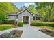 Charming clubhouse exterior featuring stone accents, lush landscaping, and a welcoming entrance at 7104 Santa Fe Pkwy, Atlanta, GA 30350