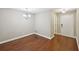 This dining room includes hardwood flooring and a designer chandelier at 7104 Santa Fe Pkwy, Atlanta, GA 30350