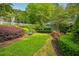 Well-maintained grounds featuring lush greenery, colorful flowers, and a serene bench at 7104 Santa Fe Pkwy, Atlanta, GA 30350