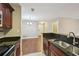 Close up of a kitchen featuring dark cabinets and granite countertops at 7104 Santa Fe Pkwy, Atlanta, GA 30350