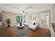 Cozy living room with wood floors, ceiling fan, and balcony access for a blend of style and comfort at 7104 Santa Fe Pkwy, Atlanta, GA 30350