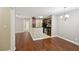 Open concept living room and kitchen with hardwood flooring and granite countertop at 7104 Santa Fe Pkwy, Atlanta, GA 30350