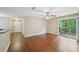 The living room is equipped with hardwood floors, a ceiling fan, and a sliding door to the outside patio at 7104 Santa Fe Pkwy, Atlanta, GA 30350