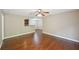 An open floor plan displays hardwood flooring, a ceiling fan, and seamless connectivity to the kitchen area at 7104 Santa Fe Pkwy, Atlanta, GA 30350