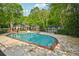 Inviting community pool with seating, set among lush greenery and trees, offering a serene escape at 7104 Santa Fe Pkwy, Atlanta, GA 30350