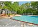 Community pool area framed by lush greenery and trees, a perfect oasis for relaxation at 7104 Santa Fe Pkwy, Atlanta, GA 30350