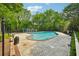 Relaxing community pool surrounded by mature trees and lounge areas, perfect for leisure at 7104 Santa Fe Pkwy, Atlanta, GA 30350