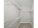 Walk-in closet with metal shelving and neutral carpet at 7104 Santa Fe Pkwy, Atlanta, GA 30350