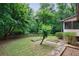 Large green back yard, enclosed by wood fence, and featuring raised garden beds at 10565 Shallowford Rd, Roswell, GA 30075