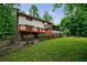 Expansive backyard showcasing a deck, screened porch, and lush landscaping at 10565 Shallowford Rd, Roswell, GA 30075