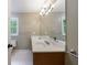 Functional bathroom with a double sink vanity, large mirror and a well lit vanity area at 10565 Shallowford Rd, Roswell, GA 30075