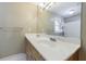 Bathroom with a double sink vanity, large mirror, and a view of the shower/tub combo, creating a functional layout at 10565 Shallowford Rd, Roswell, GA 30075