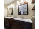 Bathroom featuring dual dark wood vanities and shelving at 10565 Shallowford Rd, Roswell, GA 30075