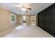 Bedroom featuring carpet, built-ins, and a window at 10565 Shallowford Rd, Roswell, GA 30075