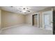 Spacious bedroom featuring neutral colored walls, carpeted floors, and access to closet and hallways at 10565 Shallowford Rd, Roswell, GA 30075