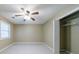 Bedroom featuring a ceiling fan, a window for natural light, and a closet at 10565 Shallowford Rd, Roswell, GA 30075