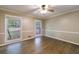 Cozy bedroom featuring hardwood floors, natural light from the windows, and neutral wall colors at 10565 Shallowford Rd, Roswell, GA 30075