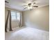 Bedroom featuring neutral walls, carpet, and window with sheer curtains at 10565 Shallowford Rd, Roswell, GA 30075