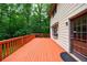 Side view of wooden deck with exterior door on a charming home with beautiful natural surroundings at 10565 Shallowford Rd, Roswell, GA 30075
