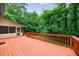 Expansive outdoor deck with a lush, wooded backdrop, perfect for entertaining and relaxation at 10565 Shallowford Rd, Roswell, GA 30075
