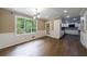 Bright dining room with hardwood floors, wainscotting and view to the kitchen at 10565 Shallowford Rd, Roswell, GA 30075
