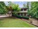 Charming two-story home with stone accents, attached garage, and lush greenery at 10565 Shallowford Rd, Roswell, GA 30075