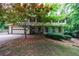 Beautiful two-story home with stone details, mature trees, and an attached garage at 10565 Shallowford Rd, Roswell, GA 30075