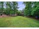 Spacious front yard leading to a two-story home with mature trees and landscaping at 10565 Shallowford Rd, Roswell, GA 30075