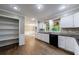 Spacious kitchen featuring white cabinets, granite countertops, and hardwood floors at 10565 Shallowford Rd, Roswell, GA 30075