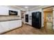 Well-lit kitchen featuring white cabinets, granite countertops, and wood floors at 10565 Shallowford Rd, Roswell, GA 30075