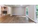 Bright living room featuring a stone fireplace, built-in shelving, and hardwood floors at 10565 Shallowford Rd, Roswell, GA 30075