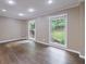 Bright living room with hardwood floors and large windows overlooking the backyard at 10565 Shallowford Rd, Roswell, GA 30075