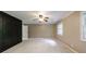 Carpeted main bedroom with large closet, a ceiling fan and a window allowing natural light to fill the space at 10565 Shallowford Rd, Roswell, GA 30075