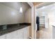 Pantry with granite countertop, white cabinets, and pendant light at 10565 Shallowford Rd, Roswell, GA 30075