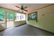 Screened in porch with indoor-outdoor carpet, access to exterior deck, and ceiling fan at 10565 Shallowford Rd, Roswell, GA 30075