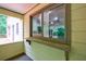 Porch featuring a window into the screened-in porch, with view of the surrounding wooded area at 10565 Shallowford Rd, Roswell, GA 30075