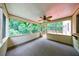 Large screened-in porch featuring indoor-outdoor carpet, and views of wooded surroundings at 10565 Shallowford Rd, Roswell, GA 30075