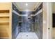 Shower stall featuring tile surround and built-in shelving at 10565 Shallowford Rd, Roswell, GA 30075