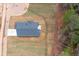 Aerial view of a home with a dark roof, long driveway, and flat, grassy yard at 150 Doris Path, Dallas, GA 30157