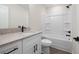 Bathroom featuring white vanity, granite countertops, tub with white tile at 150 Doris Path, Dallas, GA 30157
