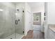 Bathroom featuring glass enclosed shower, white cabinets and granite counters at 150 Doris Path, Dallas, GA 30157