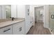 Bathroom with dual granite vanity, white cabinetry, and tile flooring at 150 Doris Path, Dallas, GA 30157
