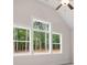 Bright bedroom with vaulted ceiling, large windows showcasing wooded backyard views at 150 Doris Path, Dallas, GA 30157