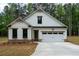 Charming white exterior with stone accents and a two-car garage at 150 Doris Path, Dallas, GA 30157