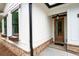 Inviting front porch with a stained wood door and stone detailing at 150 Doris Path, Dallas, GA 30157