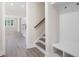 Hallway featuring hardwood floors, stairs, and a built-in storage area at 150 Doris Path, Dallas, GA 30157