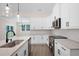 Open kitchen featuring stainless steel appliances, granite countertops, and modern white cabinetry at 150 Doris Path, Dallas, GA 30157