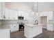 Modern kitchen with white cabinets, stainless steel appliances, an island, and stylish pendant lighting at 150 Doris Path, Dallas, GA 30157