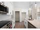 Well-lit kitchen with white cabinets, stainless steel appliances, quartz countertop, and center island at 150 Doris Path, Dallas, GA 30157