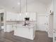 Bright kitchen with white cabinets, a center island, stainless steel appliances, and modern pendant lights at 150 Doris Path, Dallas, GA 30157